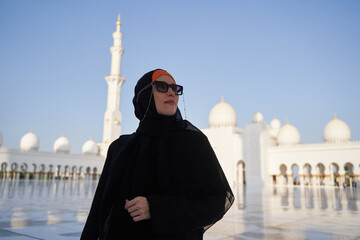 European woman is wearing women's arab national clothes in mosque.