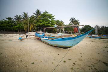 Fototapeta na wymiar fishing boats leaning on the beach, Ujung Genteng Sukabumi Indonesia