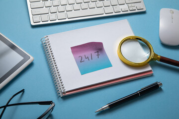 24/7 on sticky note with a computer keyboard.