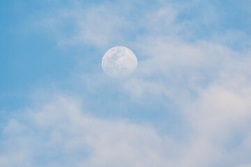 Waxing Gibbous Moon with clouds during daylight