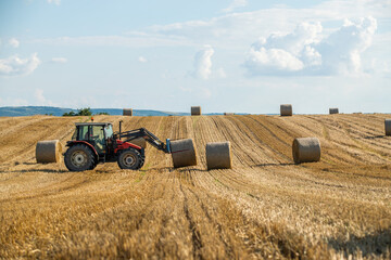 Golden fields, bales of wheat rolling through the landscape like a sea of treasure as the sun sets...