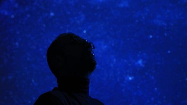 Silhouette of a man with Milky Way starry skies.	
