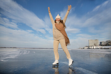 Fototapeta na wymiar cheerful woman ice skating on a frozen river in winter nature. Enjoying the little things. Winter Vibes. christmas holiday 