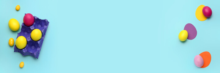 Banner with Easter eggs and space for text on light blue background