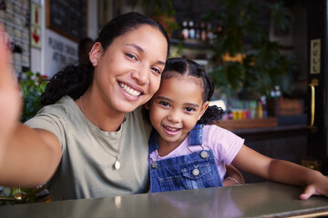 Cafe, black family and selfie with a mother and daughter enjoying spending time together in a...
