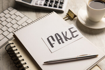 Fake is written on paper.