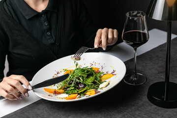 Delicious salad with figs arugula and goat cheese on white plate top view