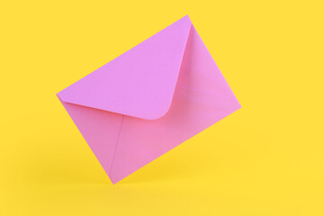 Pink paper envelope on yellow background