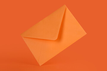 Paper envelope on orange background