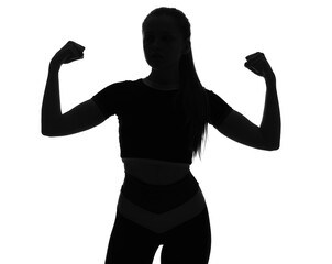 Silhouette of sporty young woman showing muscles on white background