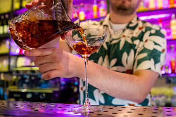 man hand bartender making cocktail in glass on the bar counter