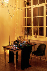 Romantic dinner table setting with festive lights