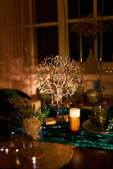 Romantic dinner table setting with festive lights