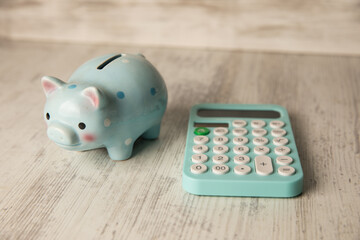 Piggy bank and calculator on the table