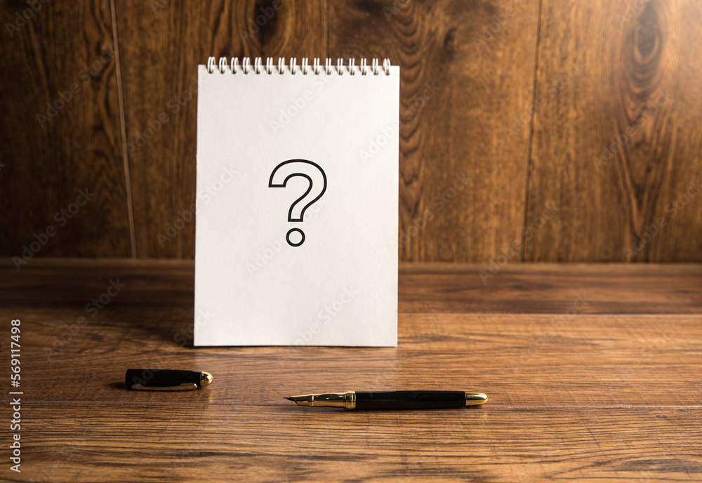 Poster question mark on a notepad.