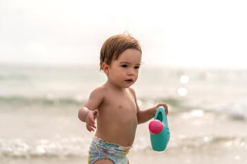 beautiful girl playing with her toy on the beach