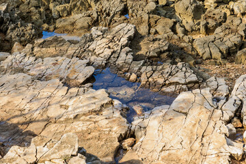 Rocky beach with blue sea at Cisterna Beach near Rovinj