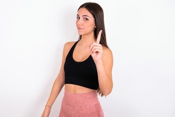 No sign gesture. Closeup portrait unhappy young woman wearing sportswear over white studio...