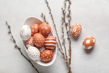 Bowl of painted Easter eggs and willow branches on light background - obrazy, fototapety, plakaty