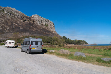 Fototapeta na wymiar Motorhome and campervan parked by the beach Playa de Orinon Cantabria North Spain located about 50 kilometres from Santander