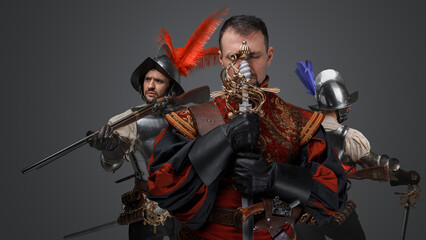 Portrait of team of conquistadors dressed in costumes with swords.