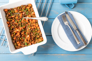 Ground beef stew with vegetables and sauce in a baking dish