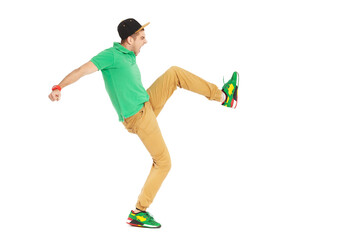 Fullbody portrait of young male kicking in studio isolated on white.