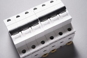 Plastic electrical circuit breaker, device, on grey background