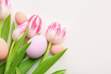 Fototapeta premium Tulip flowers and beautiful Easter eggs on white background, closeup