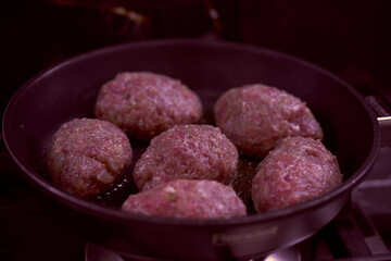 meat cutlets are fried in a frying pan in the kitchen