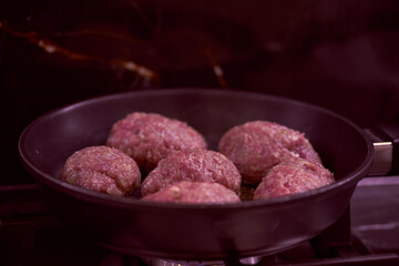 meat cutlets are fried in a frying pan in the kitchen