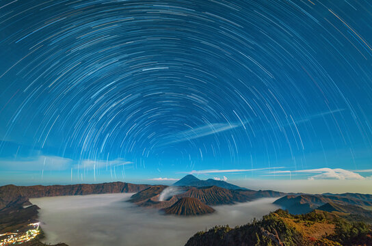 Star trails over the volcano. Clouds. Night