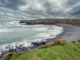 Stunning rough coast line of Ireland near Bridges of Ross, county Clare. Irish seascape. Beautiful nature scenery with cliffs and ocean and dramatic sky. Travel landmark.