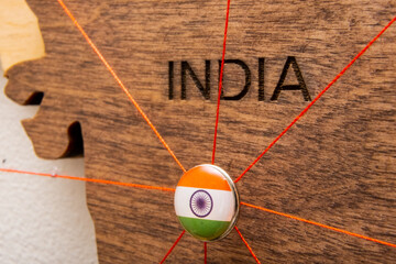 India flag pins and red thread for traveling and planning trips. Planning of logistics routes or...