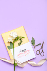 Composition with gift box, greeting card, freesia flowers and scissors on color background. Women's Day celebration