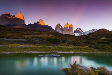 beautiful sunset casting lights on mountain peaks over the lake holiday travels during hiking