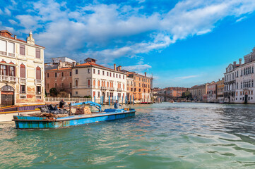 Traffic of a barge on the Grand Canal in Venice, Veneto, Italy
