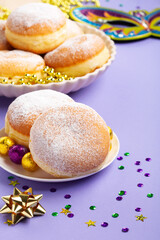 Naklejka na ściany i meble Mardi Gras King Cake Doughnuts or Donuts, Carnival Masks on Purple Background.