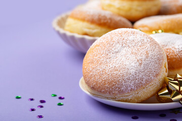 Mardi Gras King Cake Doughnuts or Donuts, Carnival Masks on Purple Background.