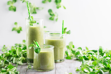 Detox diet concept: Green Spinach Smoothie on White wooden table