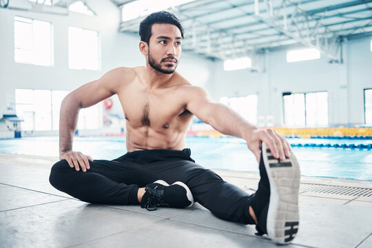 Athlete, fitness and man stretching by a pool ready for training, practice or exercise for a competition. Body, sport and male swimmer preparing for workout as health, performance and wellness - Powered by Adobe