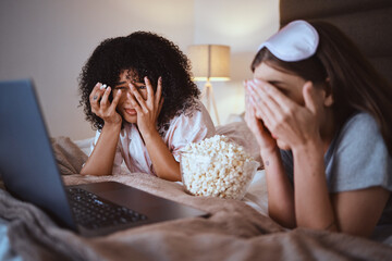 Women, horror or laptop movie in house bedroom on subscription channel, popcorn entertainment or...
