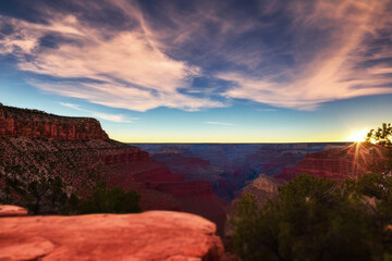 sunset over the orange red canyon in the desert