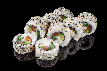 sushi roll with sesame avocado cucumber tuna and Philadelphia cheese on a black mirror background