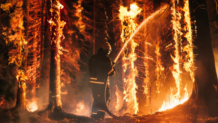 Professional Firefighter Extinguishing Large, High-Priority Part of the Forest Fire. Highly Skilled...