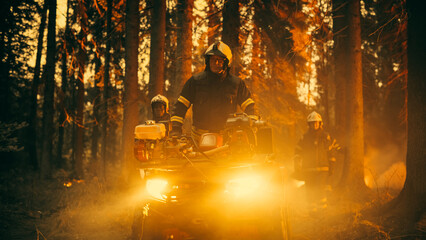 Professional Firefighters Crew Walking and Riding an ATV in Forest, Controlling a Wildland Fire Before it Becomes a Catastrophic Event. First Responders Arrive to the Forest and Assess the Situation. © Gorodenkoff