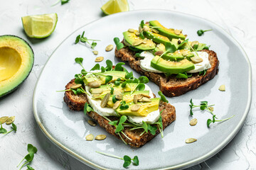 avocado toasts with cheese, pumpkin, nut and sesame. Healthy fats, clean eating for weight loss
