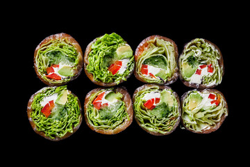 vegetarian futomaki sushi roll with cucumber, salmon, pepper, avocado salad on a black mirror background
