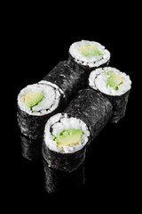 maki sushi roll with avocado on a black mirror background