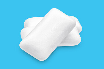 Three pieces of white chewing gum isolated on white. The whole subject is in focus.